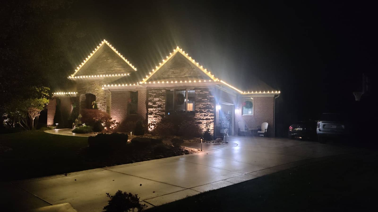 Warm-white professional Christmas light installation on a residential home in Georgetown, IN by Elite Exteriors