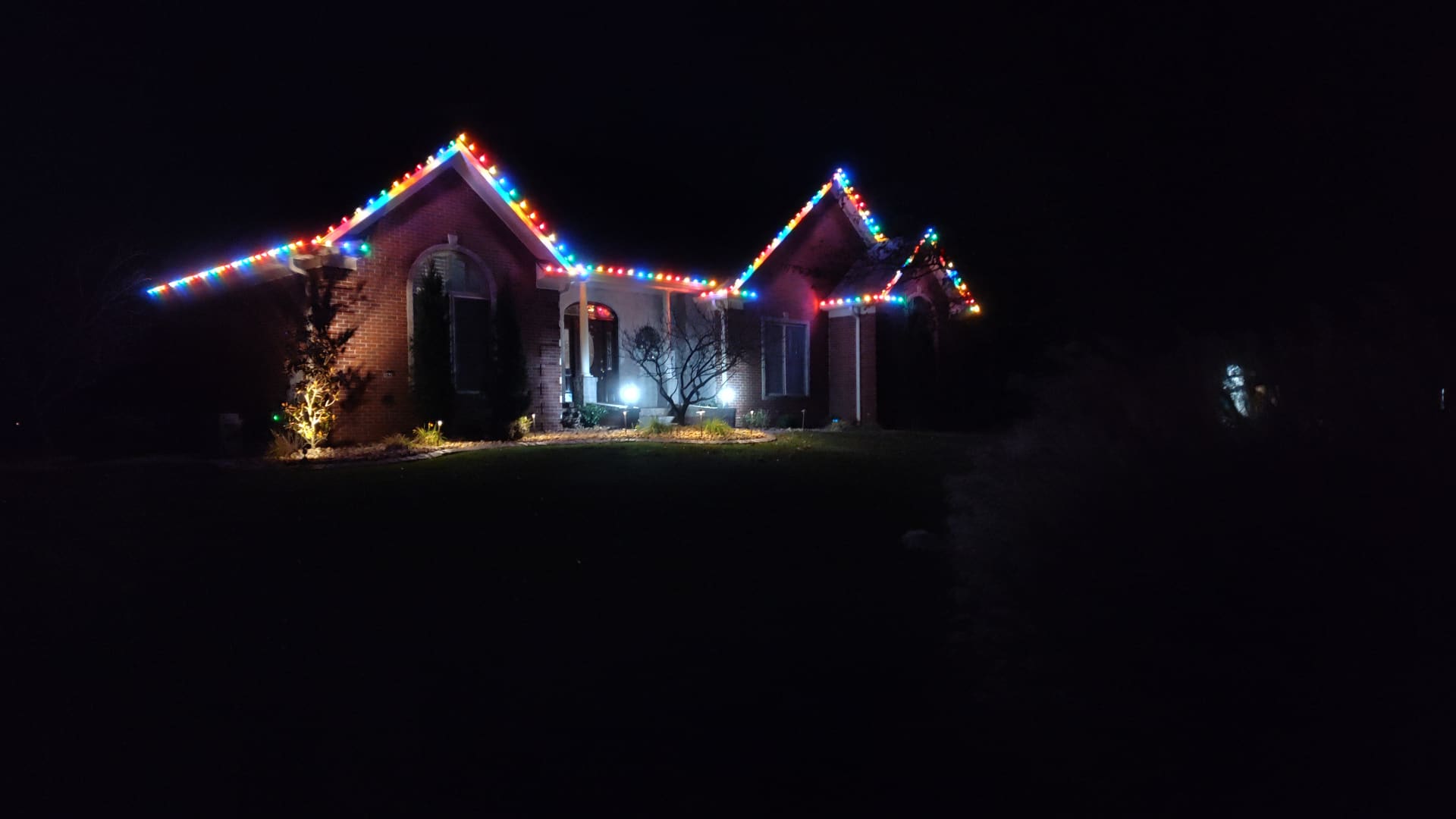 Colorful multi-hue Christmas light display on a Sellersburg, IN home installed by Elite Exteriors