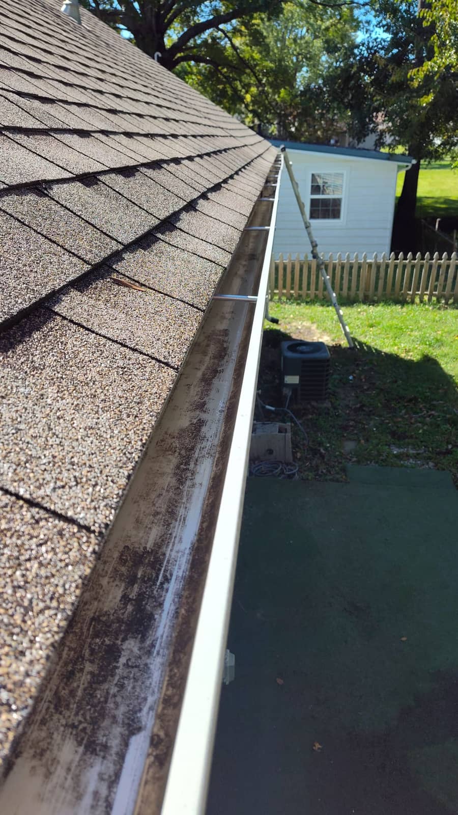 Fully cleared residential gutter and downspout after Elite Exteriors gutter cleaning service