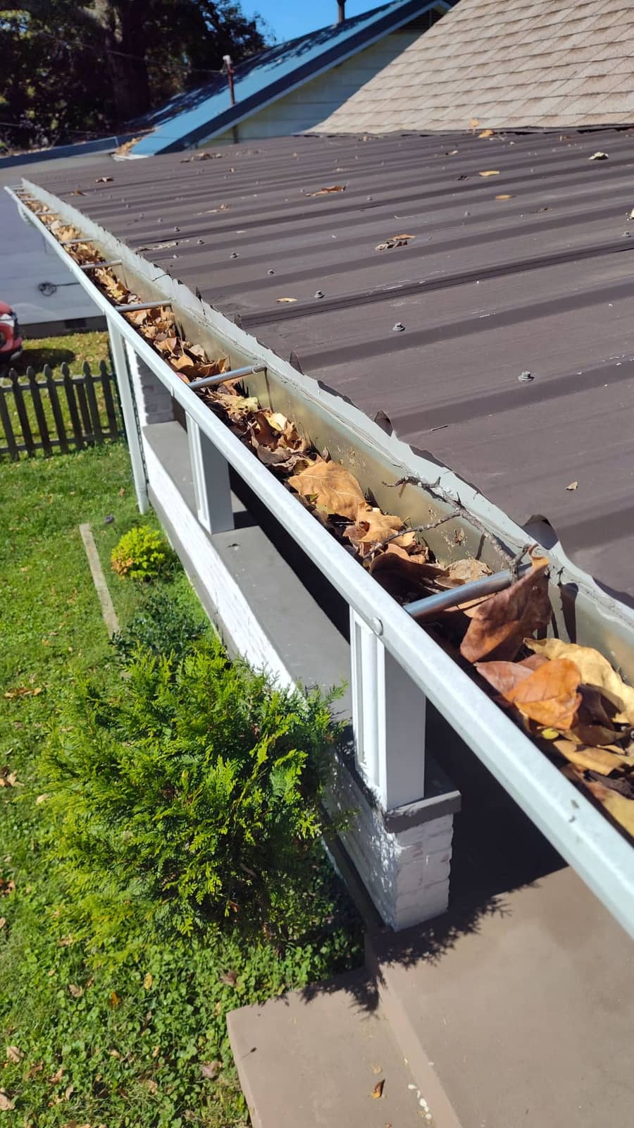 Residential gutter clogged with leaves and debris before Elite Exteriors gutter cleaning service in Southern Indiana