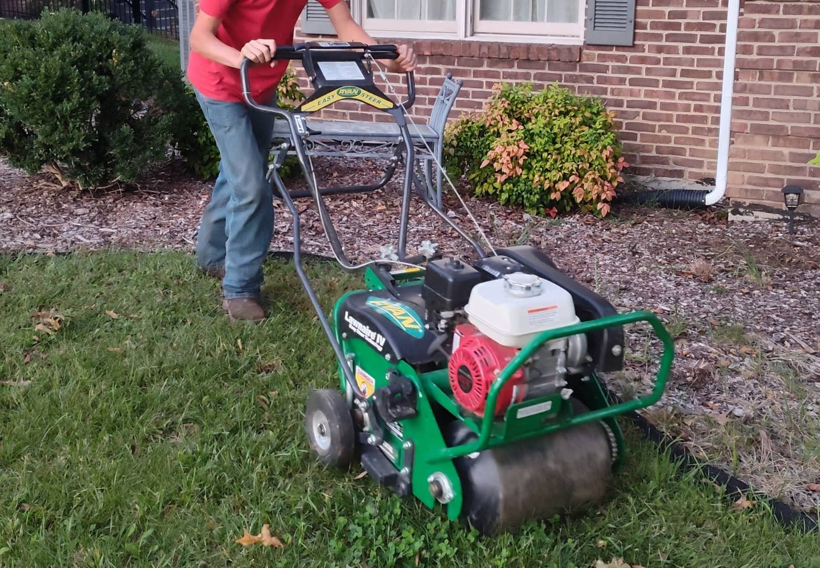 Elite Exteriors commercial core aerator machine on a residential lawn in Southern Indiana