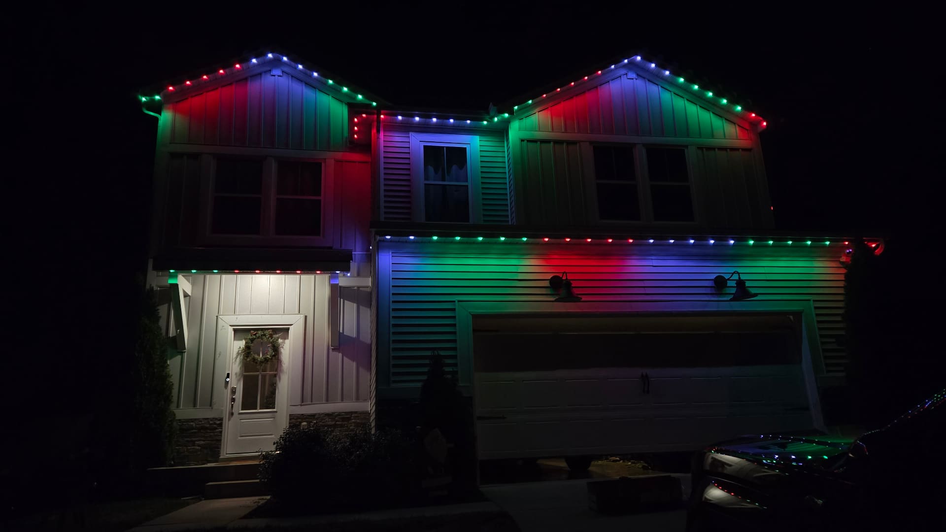 Home roofline with vibrant RGB permanent LED lighting installed by Elite Exteriors in Southern Indiana