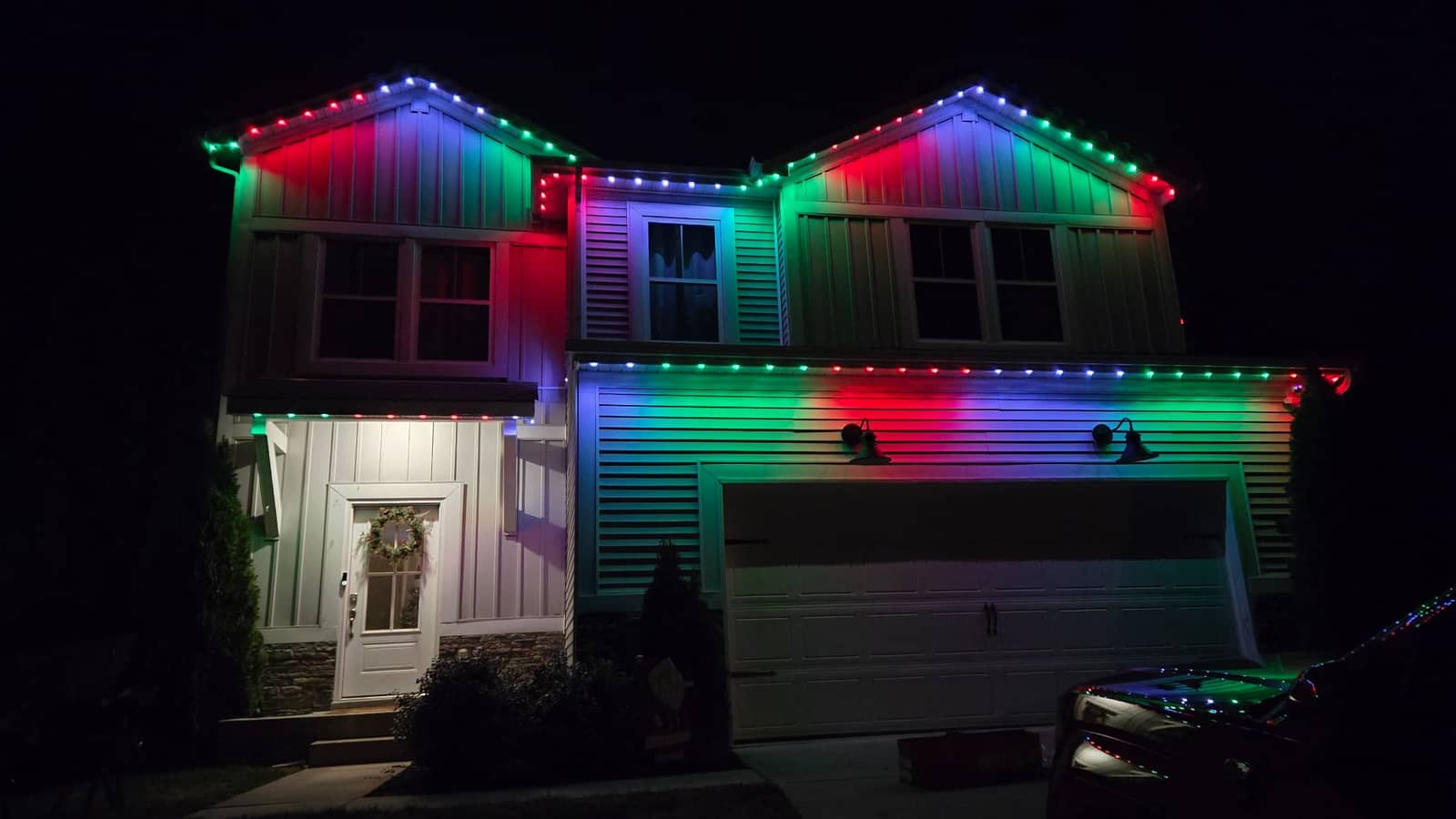 Multi-color permanent LED lighting display on a residential roofline by Elite Exteriors
