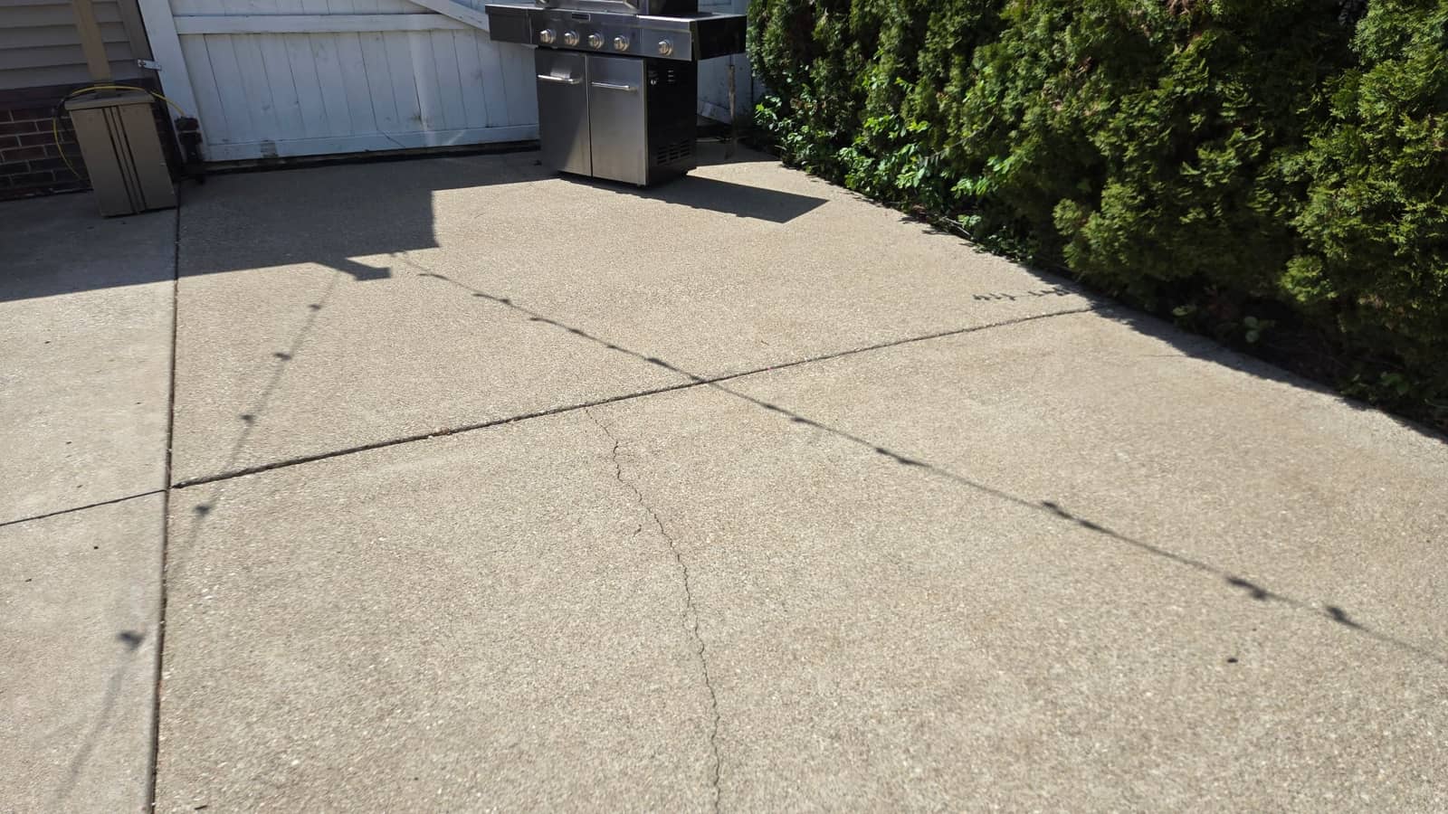 Bright, freshly pressure-washed concrete patio after Elite Exteriors professional cleaning service