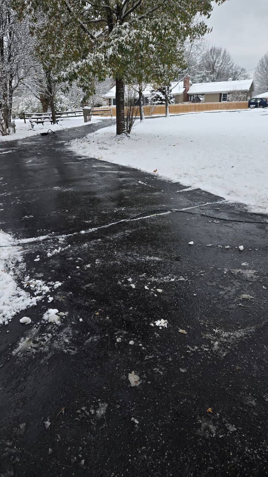Elite Exteriors team clearing heavy snow from a residential driveway in Floyds Knobs, IN