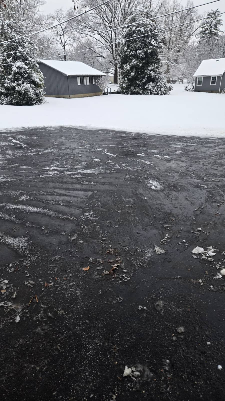 Clean, salted residential driveway after Elite Exteriors professional snow removal and de-icing service