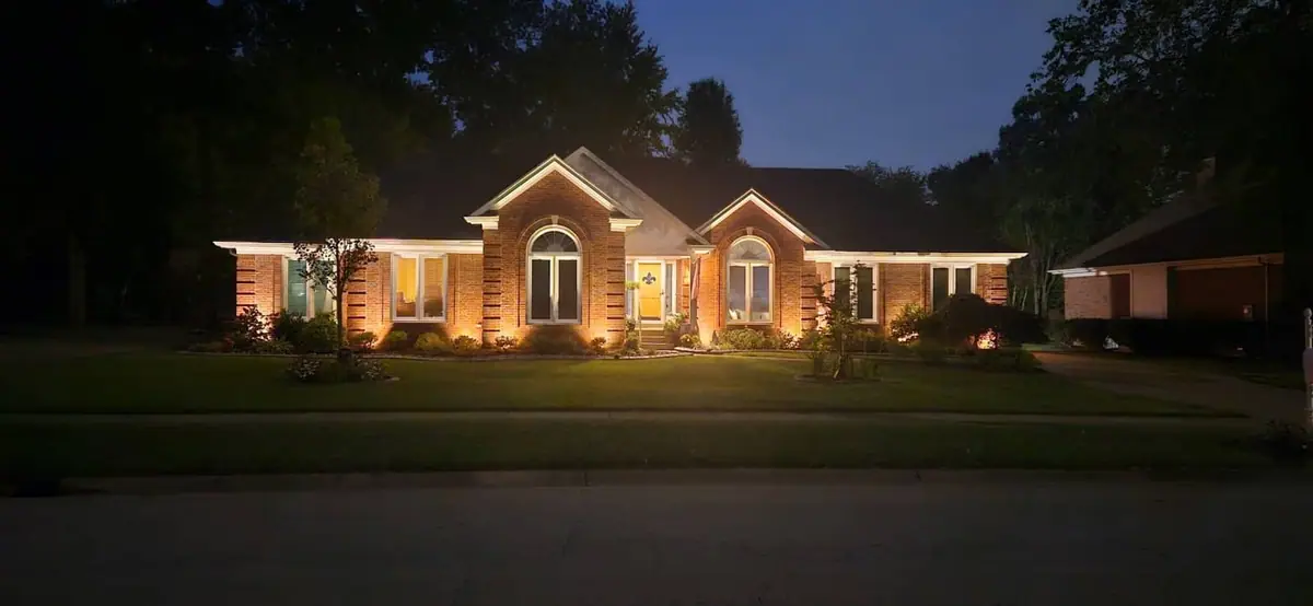 Warm white LED landscape lighting installed on a home exterior and walkway at dusk in Indiana