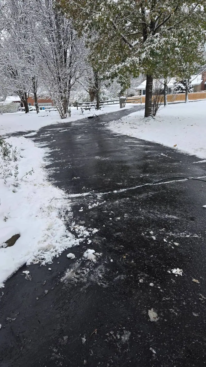 Elite Exteriors crew plowing a snow covered driveway in Floyds Knobs, Indiana during winter service